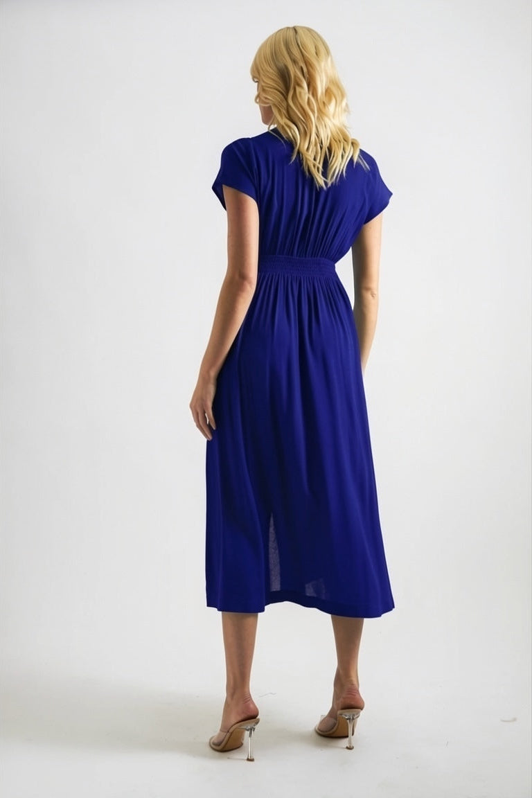 Woman wearing a blue dress against a white background
