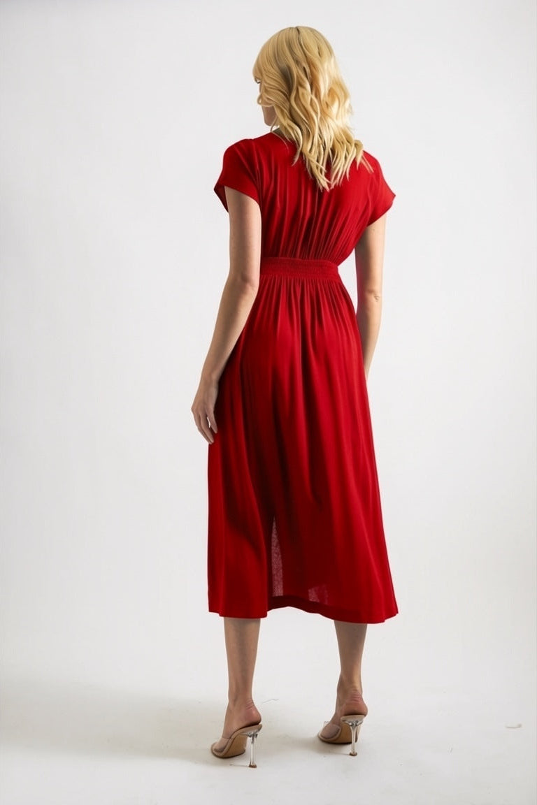 Woman wearing a red dress against a white background