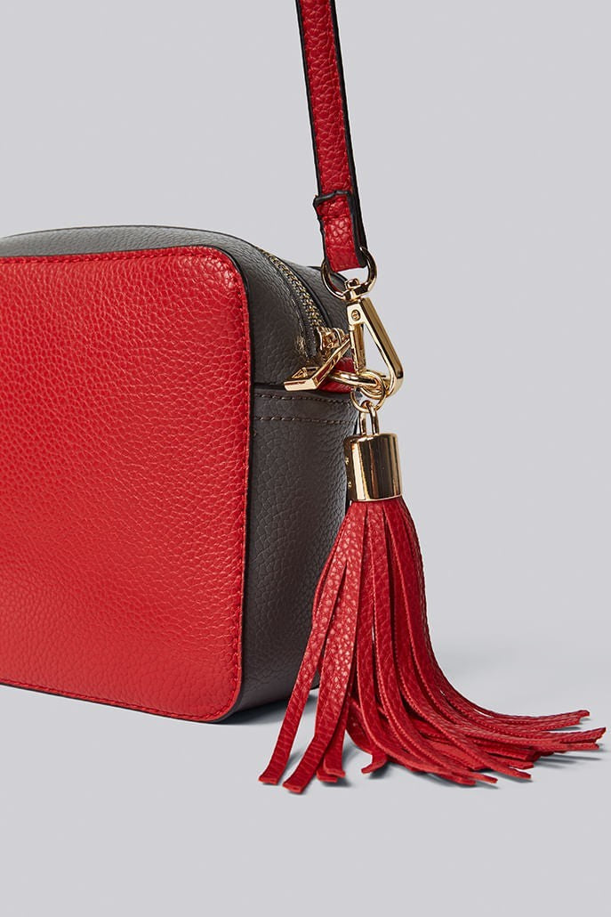 Louche Daisy camera bag — back view of red and grey panelled crossbody with gold zip closure, polyurethane.