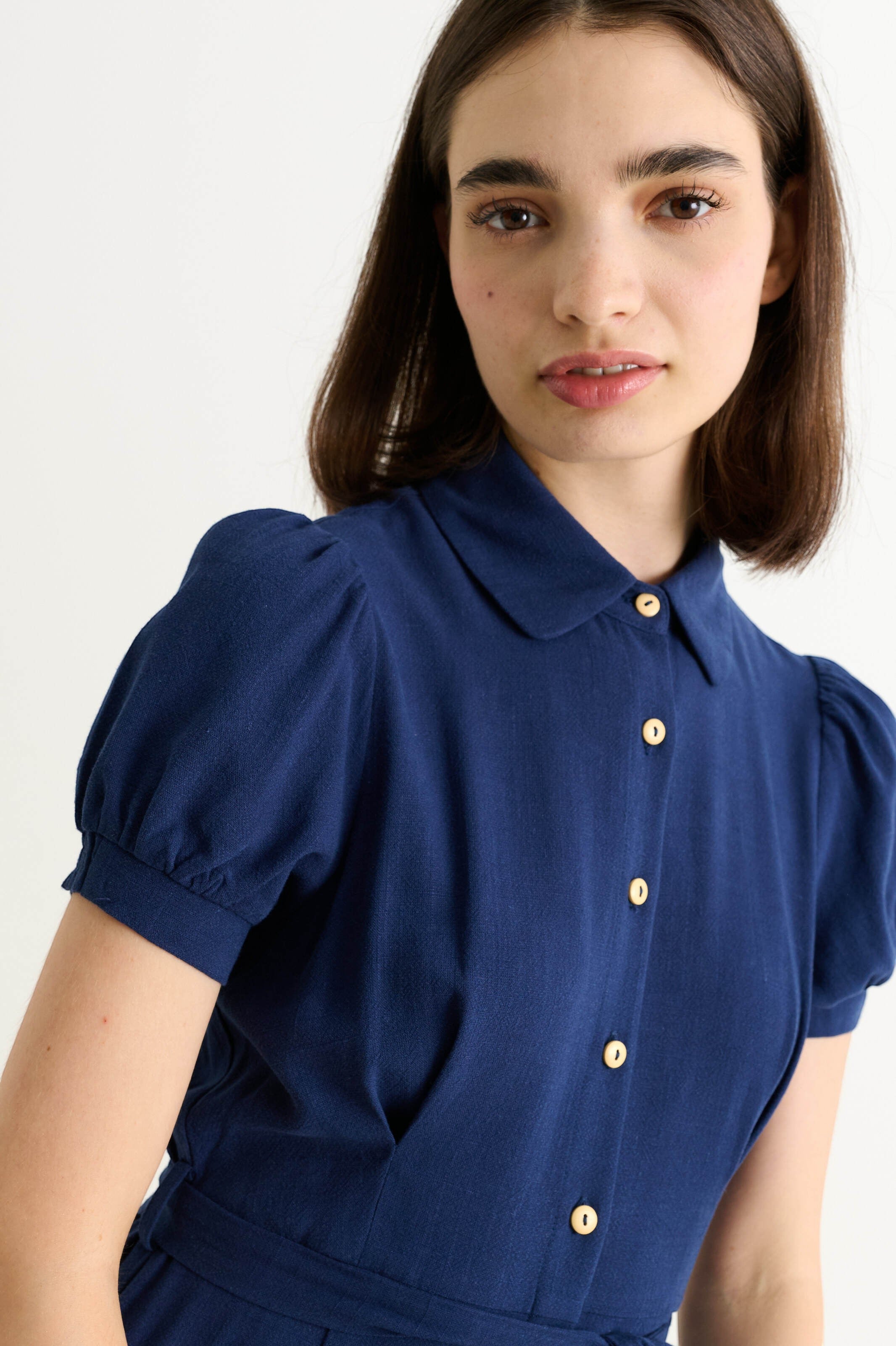 Navy blue linen mix midi shirt dress with rounded collar, puff sleeves, button front, and self-tie belt.