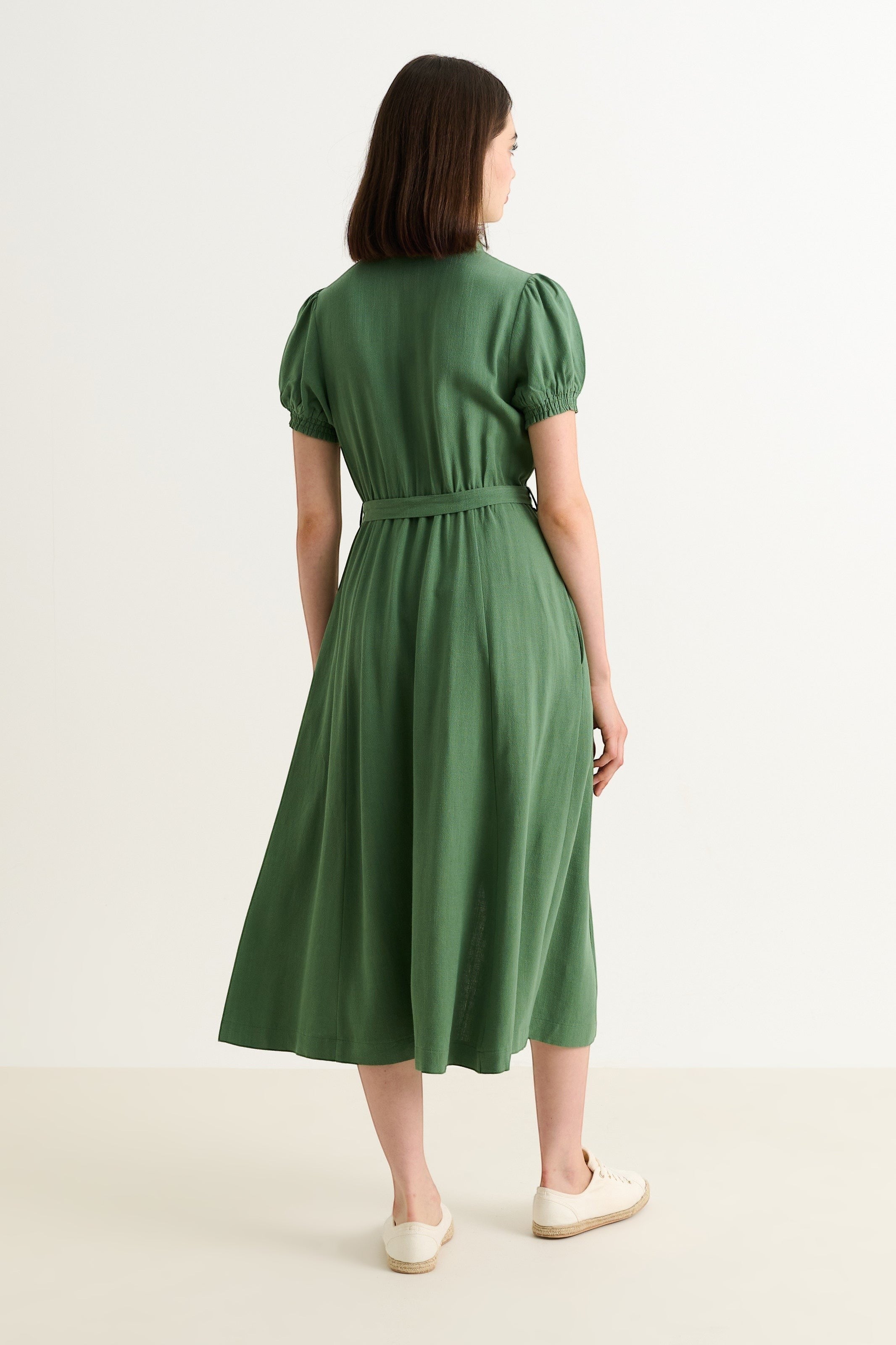Joselyne green linen mix midi shirt dress with puff sleeves and self belt, worn by a model.
