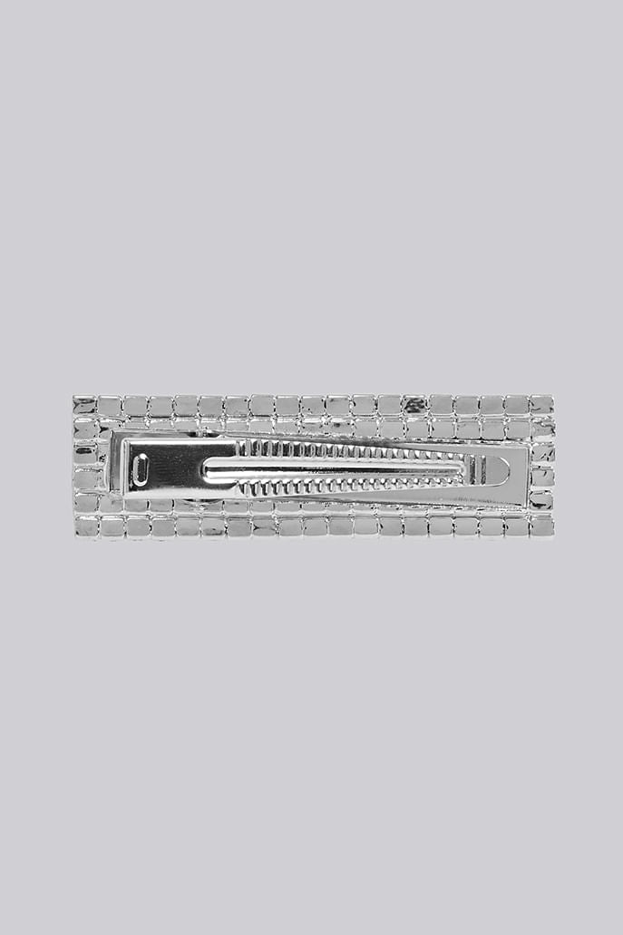 Louche Brice crystal hair clip styled — sparkling rhinestone slide worn in loose blonde hair.